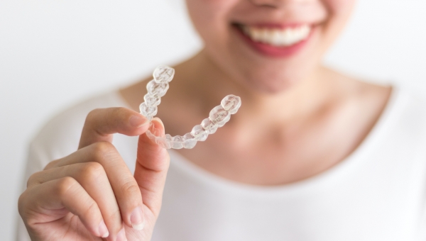 adult woman holding Invisalign